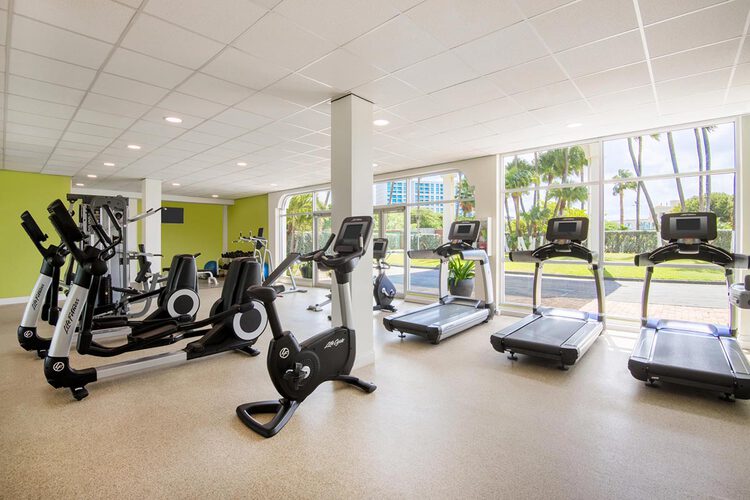 A fitness center with treadmills and elliptical machines