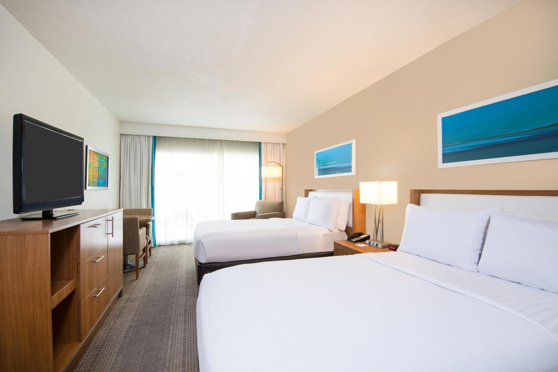 Guest room with two double beds and a TV