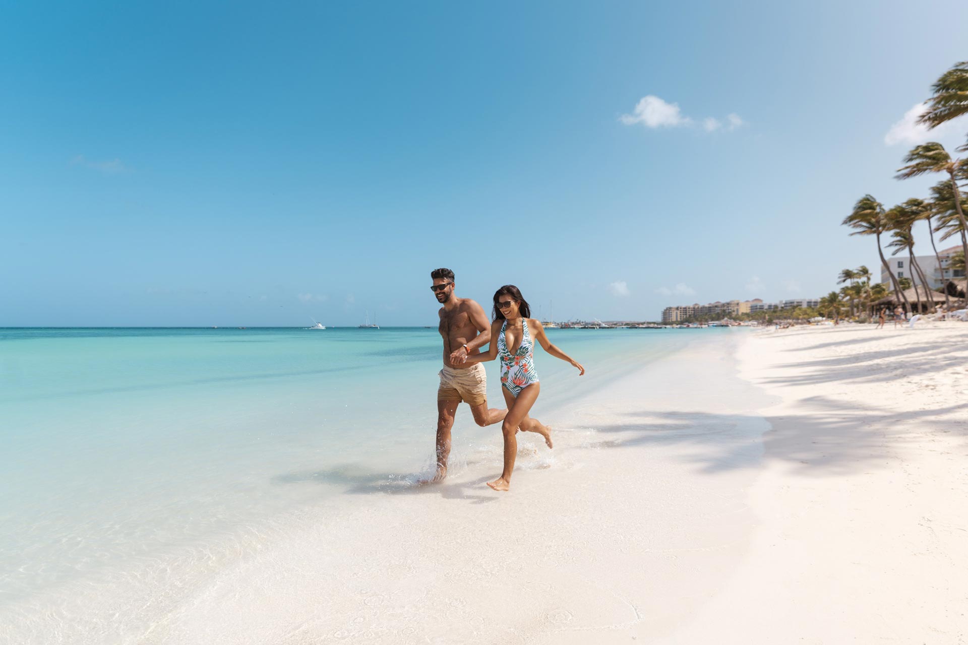 A couple running on the beach